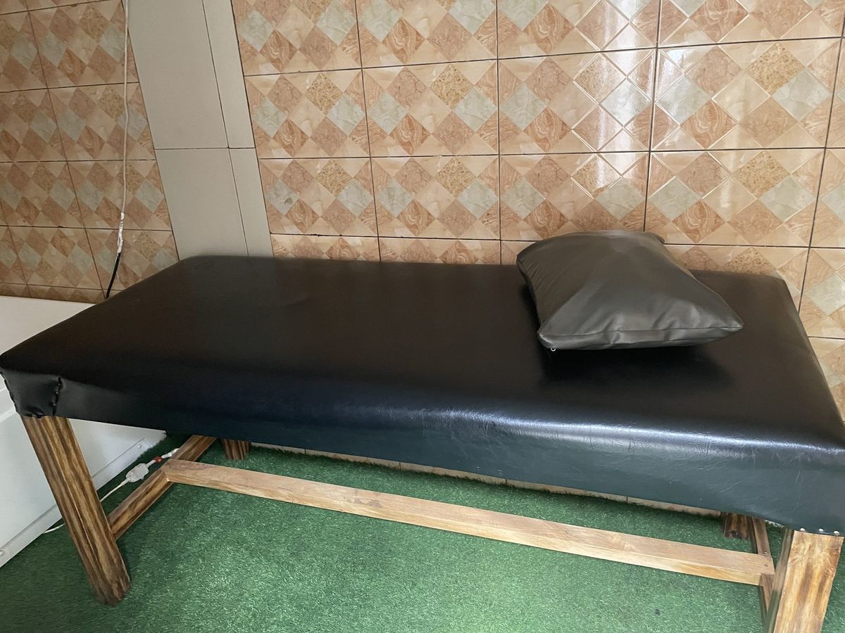 Massage table with a pillow in the treatment room