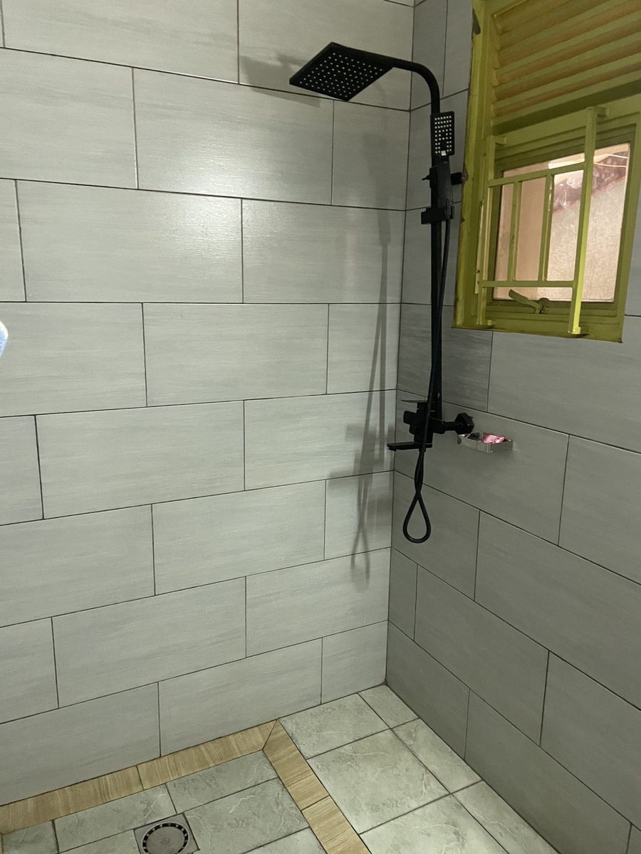 Tiled walk-in shower with black fittings