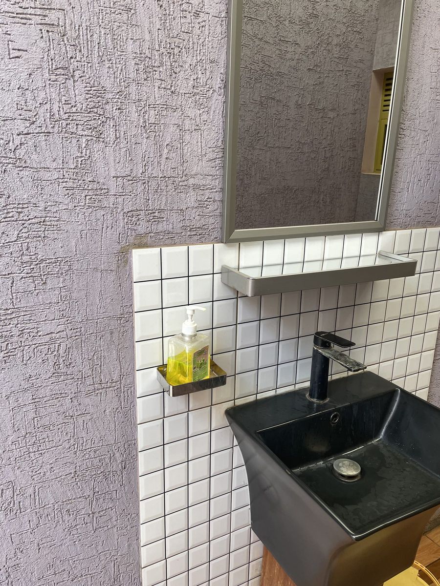 Washstand with a basin and mirror on a textured wall
