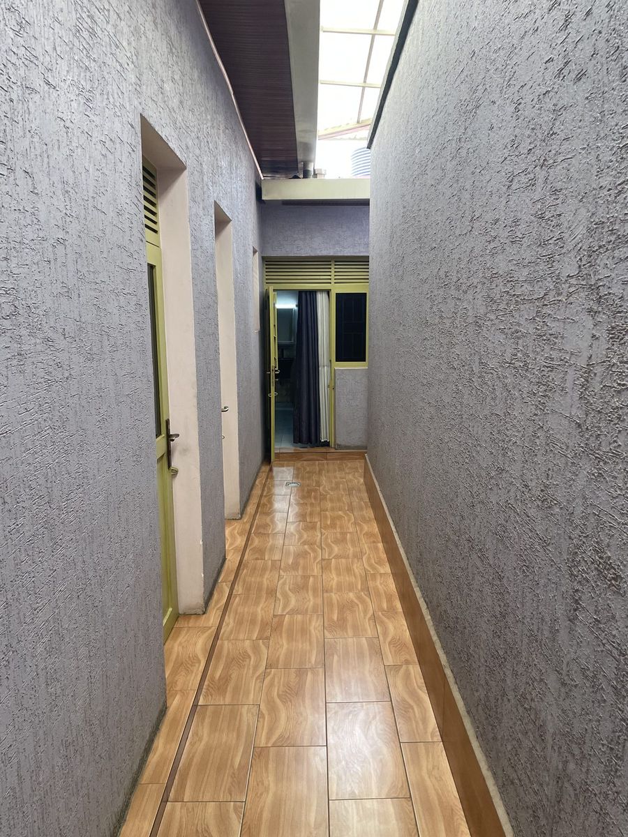 Inner corridor with a wooden floor running between the rooms