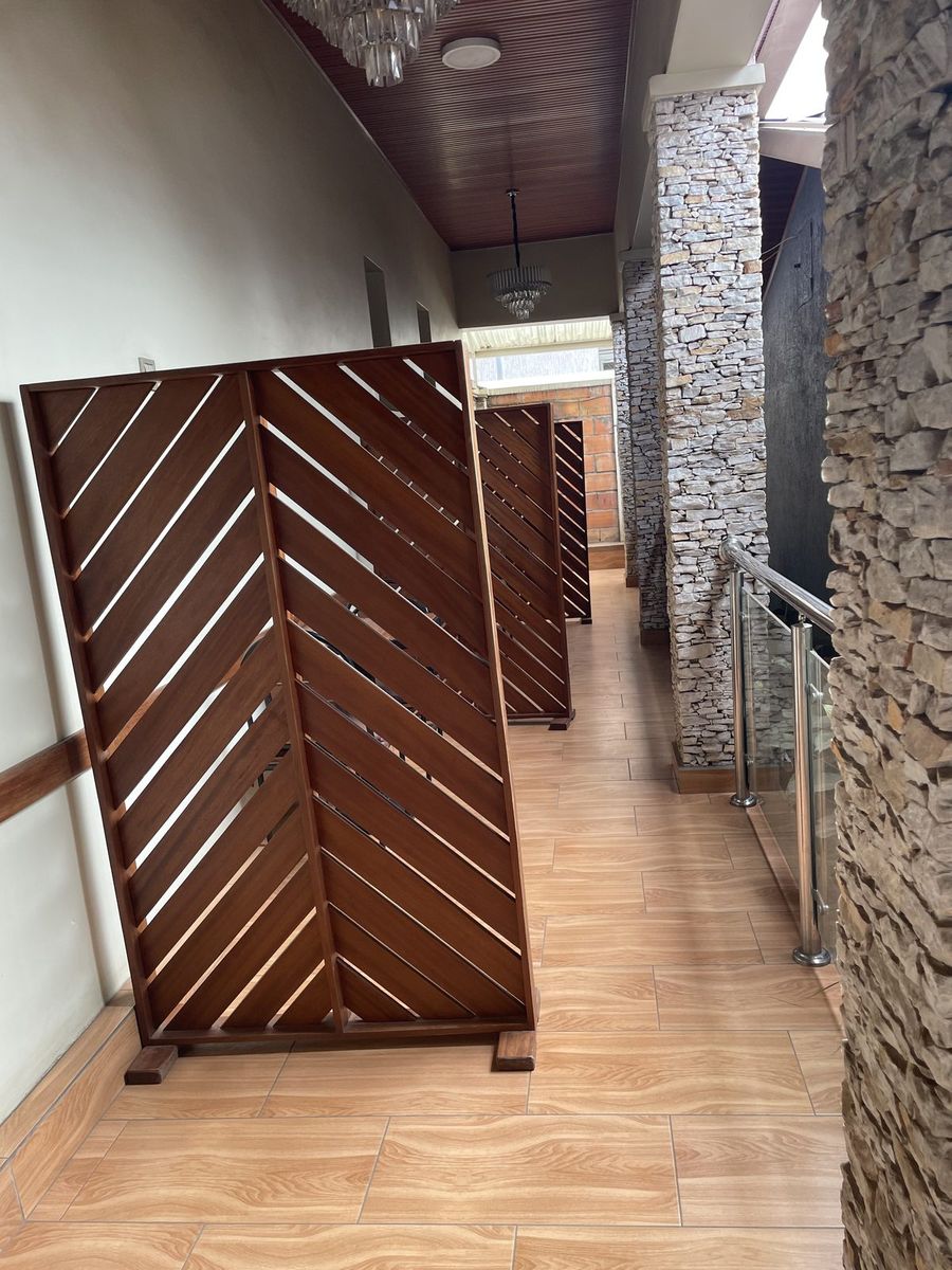 Timber screen and stone wall at the walkway entrance