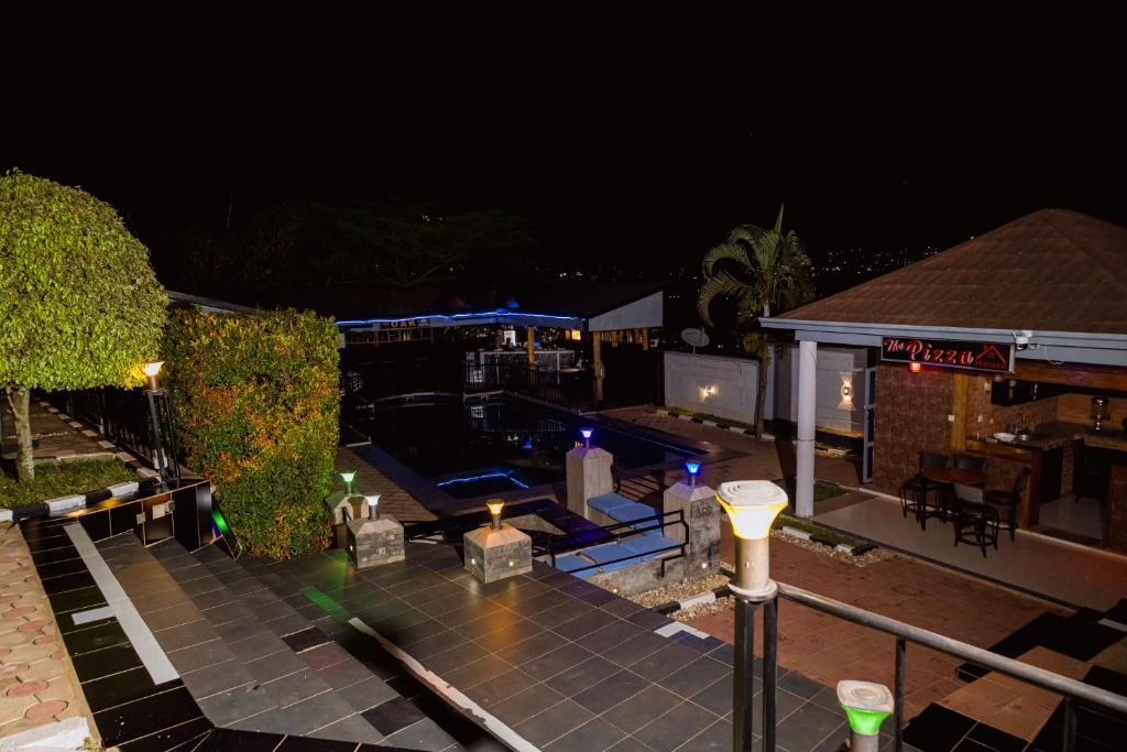 Lit garden terrace and pool deck in the evening