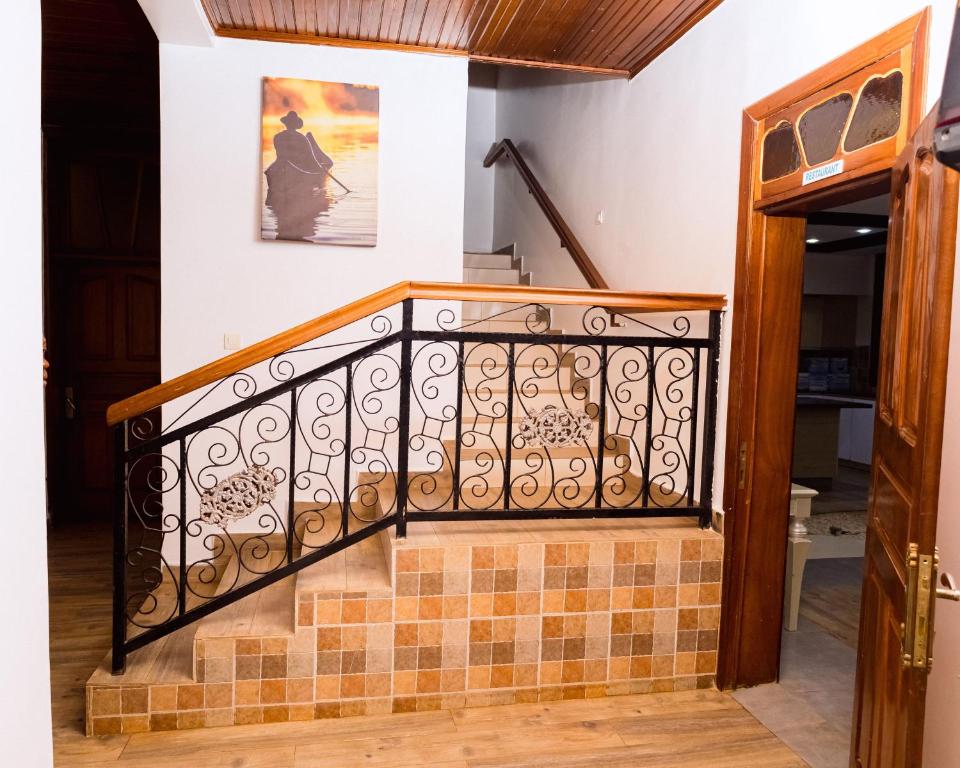 Wooden staircase with wrought iron balustrade