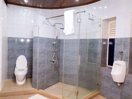 Large walk-in glass shower in a grey-tiled ensuite